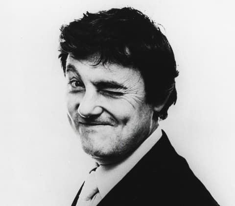 A portrait of Tobia Scarpa winking at the camera
